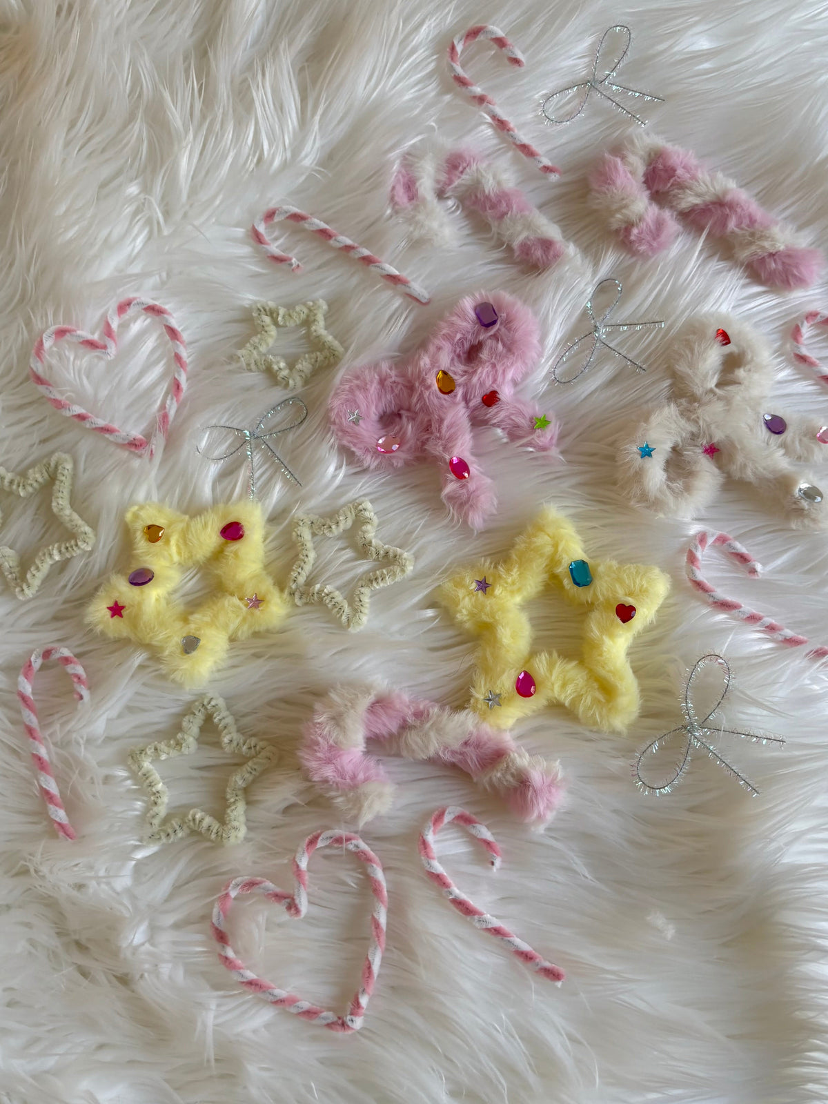 23 handmade Christmas ornaments made from colorful pipe cleaners