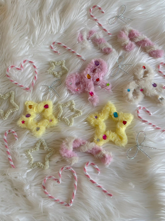23 handmade Christmas ornaments made from colorful pipe cleaners