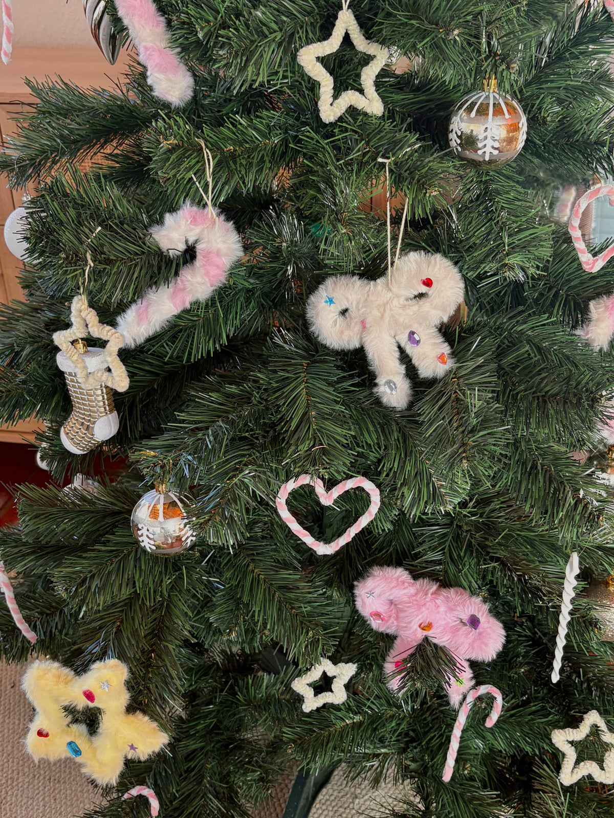 Close-up of pink and white handmade pipe cleaner Christmas ornaments