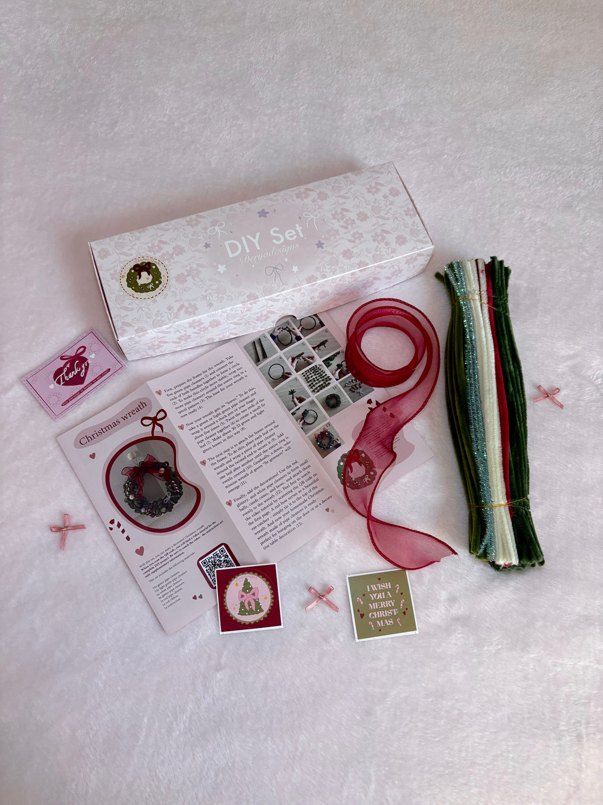 Christmas wreath DIY craft kit with pipe cleaners, red ribbon and materials for making a festive wreath