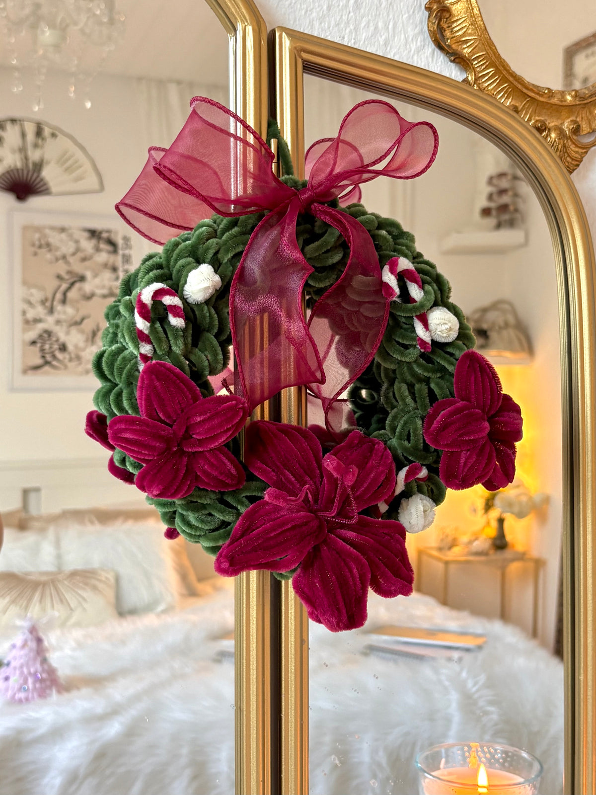 Close-up of red and white flowers on a green Christmas wreath