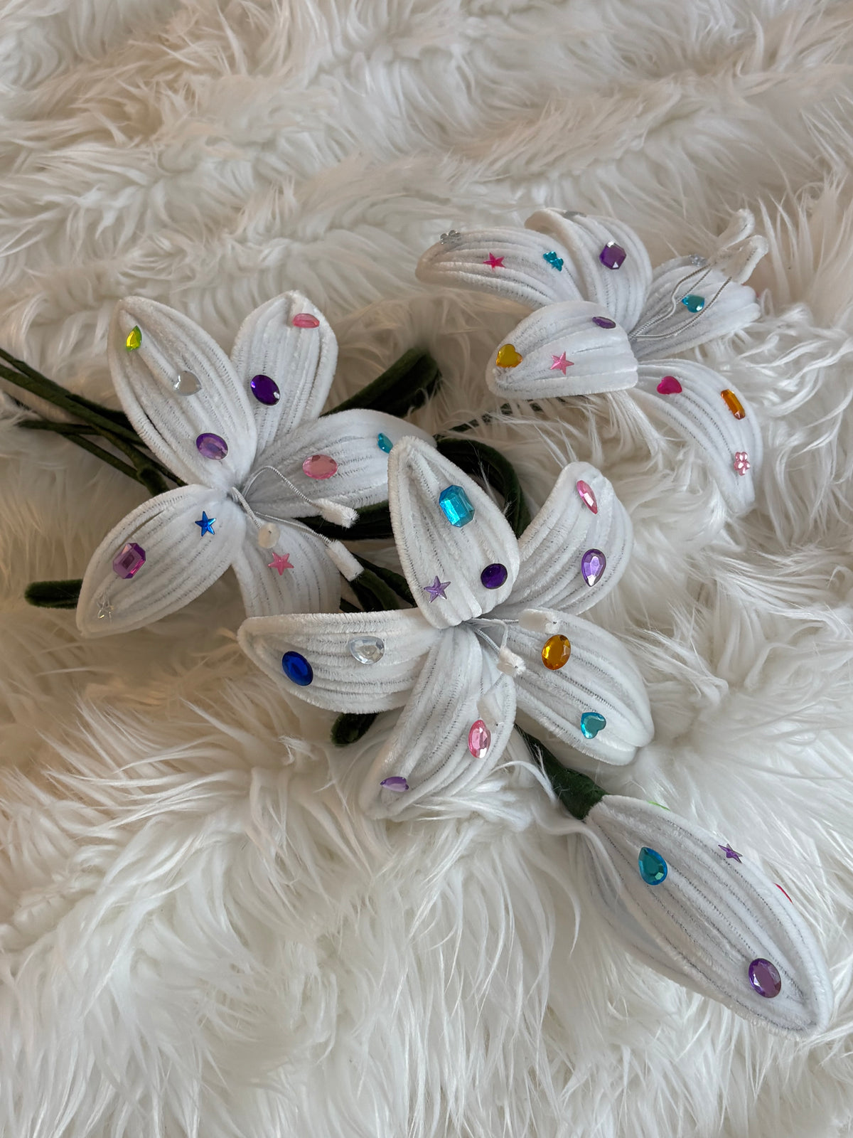 Close-up of handmade white pipe cleaner lilies